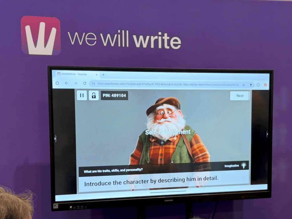 WeWillWrite prompt asking students to describe a character in detail on the classroom big screen